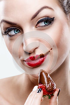 ÃÂ ÃÂ  Seduction - Attractive woman eating a strawberry, chocolate became the face of it photo