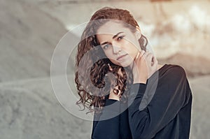 Seductive beautiful curly girl, portrait on gray background