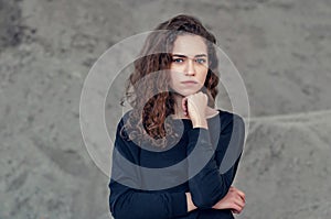 Seductive beautiful curly girl, portrait on gray background