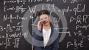 Seductive female teacher satisfied with proven theorem taking glasses off, flirt