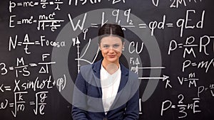 Seductive female teacher satisfied with proven theorem taking glasses off, flirt