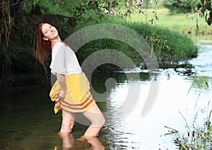 Seductive girl in skirt in water