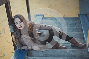 Seductive lady girl with romantic pout red lips and pinky cheeks wearing stylish jacket dress and shorts with autumn boots po