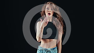 Seductive woman demonstrate astonish posing isolated on black studio. Medium shot on RED camera