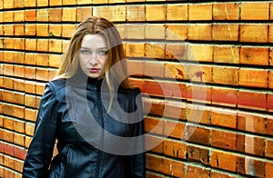 Seductive woman in front of brick wall