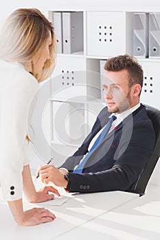 Seductive woman talking to boss