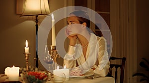 Seductive woman waiting at romantic dinner closeup. Sexy lady sitting alone