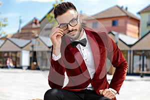 Seductive young elegant man wearing red velvet tuxedo