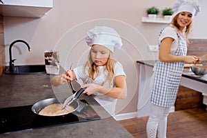 Sedulous little girl baking at home independently
