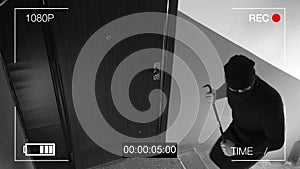 See CCTV as a burglar breaking in through the door with a crowbar