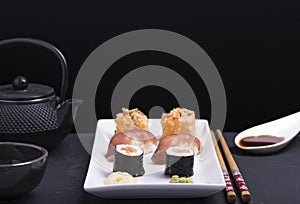 Dinner with sushi and soy sauce with black background. photo