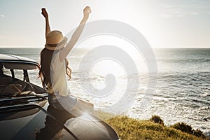 See the world in all of her beauty. a young woman enjoying a road trip along the coast.