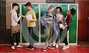 See you later buddy. a group of cheerful young school kids talking to each other before class inside of a school during