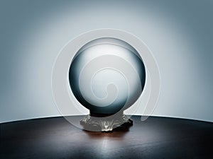 See your future in the magical crystal ball on simple dark wood table