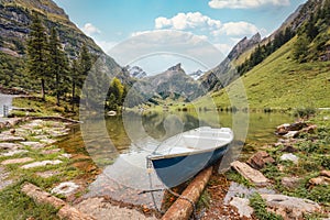 Seealpsee mountain lake and boat in Alpstein mountain range at Switzerland photo