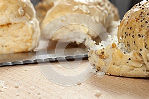 Seeded bread rolls laying on a kitchen worktop