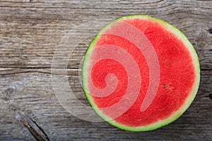 Seedless watermelon on a wooden table - top view