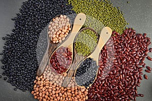 Seeds beansBlack Bean, Red Bean, Peanut and Mung Bean useful for health in wood spoons on grey background