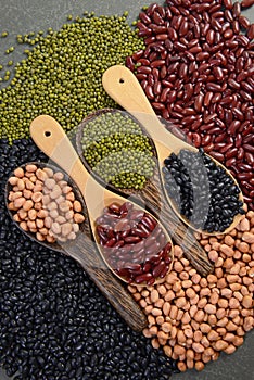 Seeds beansBlack Bean, Red Bean, Peanut and Mung Bean useful for health in wood spoons on grey background