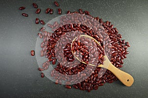 Seeds red beans useful for health in wood spoons on grey background