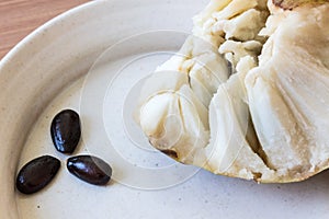Seeds separated out from ripe cherimoya Annona cherimola fruit on a shallow dish