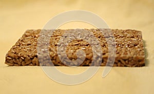 Seeds in sugar briquette on yellow background side view