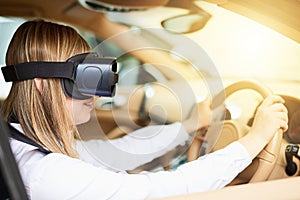 Seeing traffic with fresh eyes. a young businesswoman wearing a virtual reality headset while driving her car.
