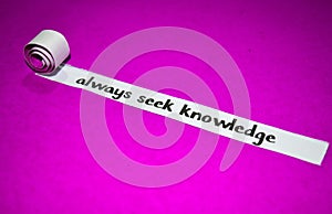 Always seek knowledge text, Inspiration, Motivation and business concept on purple torn paper