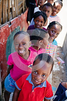 They always seem to be smiling. Cropped portrait of a group of kids at a community outreach event.