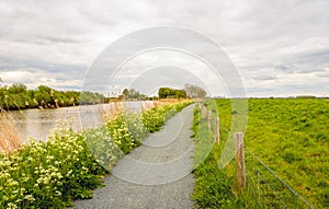 Seemingly endless cycle path next to a river and a