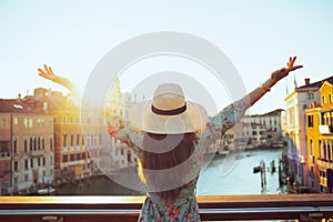 Seen from behind young solo traveller woman in floral dress