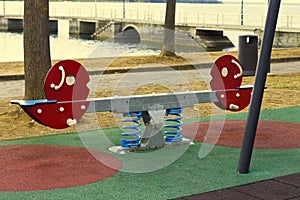 A seesaw on a children`s playground in a public park Umbria, Italy