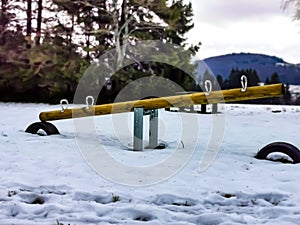 Seesaw on a snowy playground in December in Bavaria, Germany