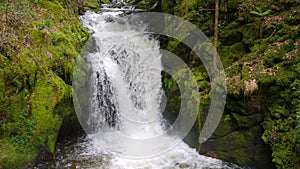 Seething picturesque clean mountain river in slow motion. The strength and beauty of a mountain stream