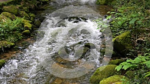 Seething picturesque clean mountain river in slow motion. The strength and beauty of a mountain stream