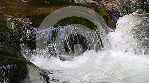 Seething picturesque clean mountain river in slow motion. The strength and beauty of a mountain stream