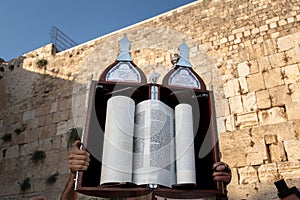 A sefardi Torah scroll is lifted during Jewish prayers at the Western Wall in Jerusalem, Israel.