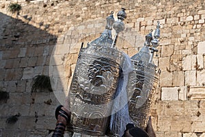 A sefardi Torah scroll is lifted toward the sky during Jewish prayers at the Western Wall in Jerusalem, Israel