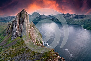 Segla Mountain from a nearby peak during sunset. The sky turned bright red orange and purple to give this image a dramatic