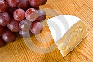 Segment of brie with grapes