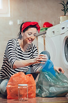 Segregating waste,a daily routine of smiling woman