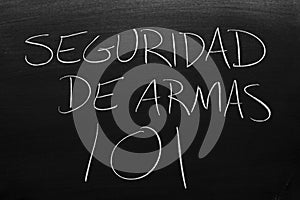 Seguridad De Armas 101 On A Blackboard. Translation: Gun Safety 101 photo