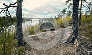 Seid or megalith, stone with legs on bald mountain above Lake Iloranta. Beautiful northern nature late autumn
