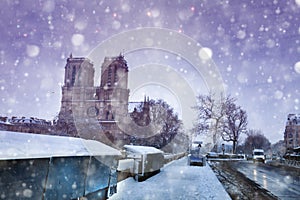 Seine bank and Notre Dame de Paris under snow