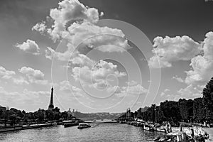 Seine river with Eiffel tower on the background under a cloudy sky