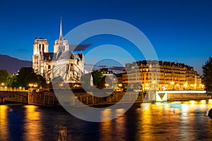 Seine river and Notre Dame de Paris at night in Paris, France photo