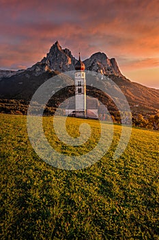 Seis am Schlern, Italy - Beautiful sunset and idyllic mountain scenery in the Italian Dolomites with St. Valentin Church