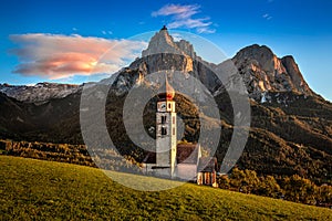 Seis am Schlern, Italy - The famous St. Valentin Church and Mount Sciliar mountain at sunset. Idyllic mountain scenery