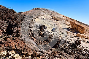 Seismic equipment does research on the top of the volcano among the rocks