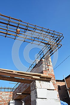 Seismic resistant house corner construction. Rebar steel bars, reinforcement concrete bars with wire rod as a lintel for windows photo